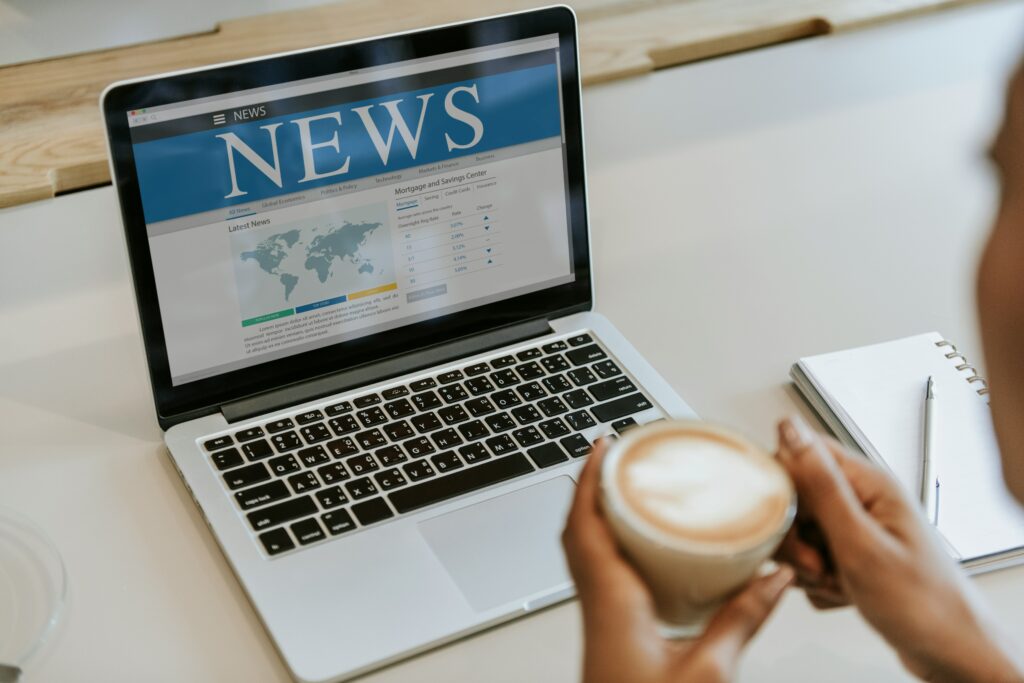 Press Release Distribution for Business News 1 A person drinking coffee while looking at their business news.