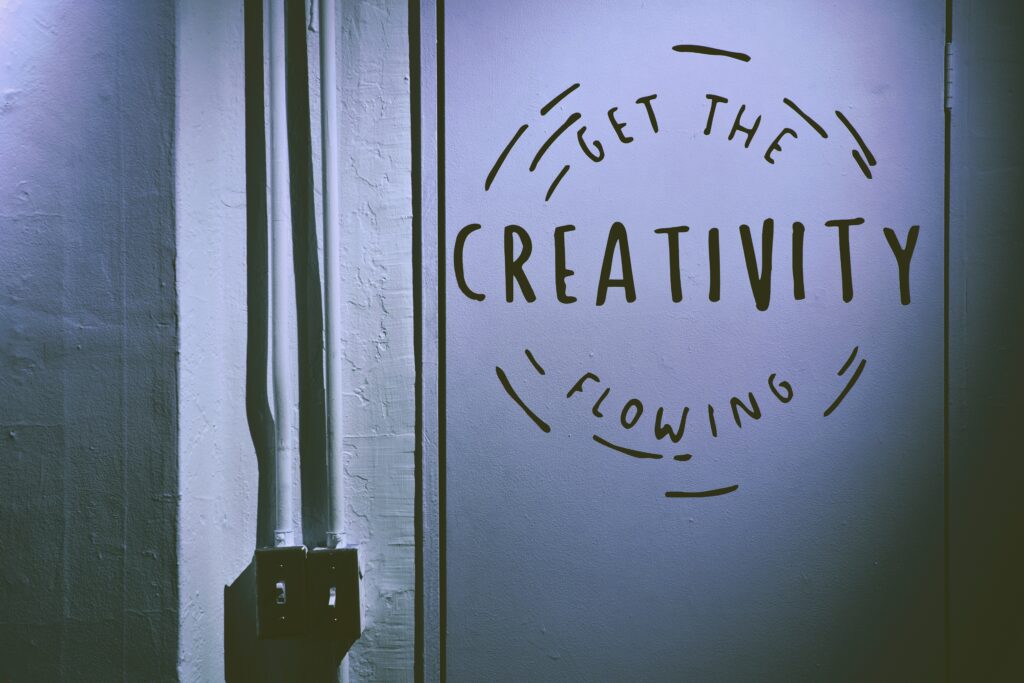 Outsourcing Press Release Distribution is a Game-Changer for PR Professionals 2 An photograph of a wall with the words "Get the creativity flowing" painted on it.